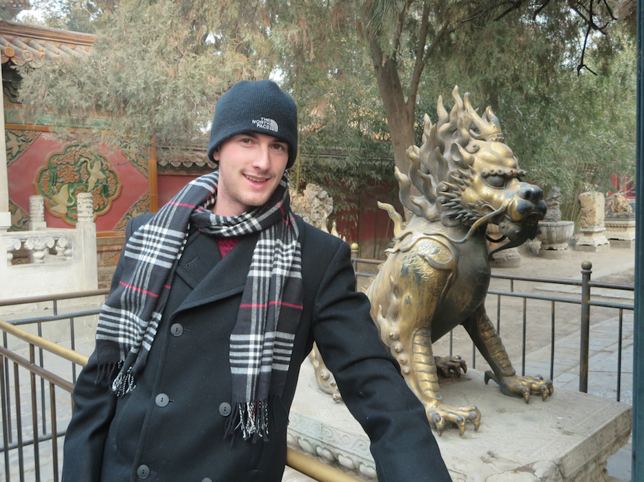 梁剑 (Josh) with a dragon statue.