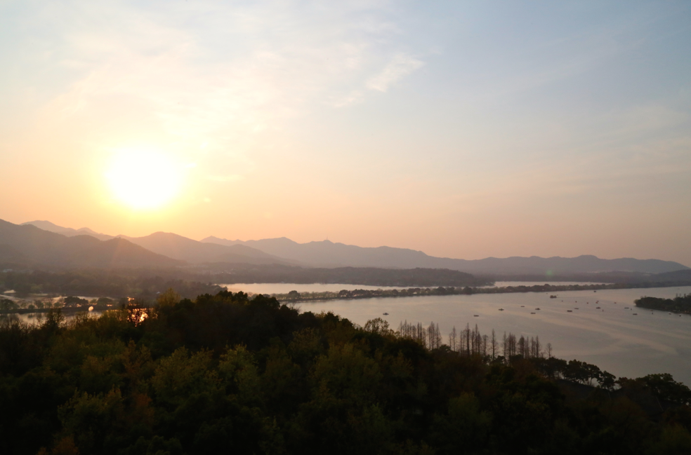 We climbed up to a high tower to see the sunset across the West Lake